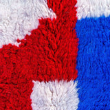 beautiful Beni Ourain rug, crafted from organic wool with soft blue and red hues. Perfect balance