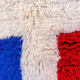 beautiful Beni Ourain rug, crafted from organic wool with soft blue and red hues. Perfect balance