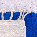 beautiful Beni Ourain rug, crafted from organic wool with soft blue and red hues. Perfect balance