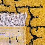 Taliouine Moroccan Rug, saffron yellow with black patterns in 100% wool, inspired by the vibrant culture of southern Morocco