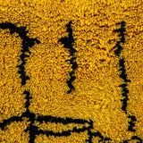 Taliouine Moroccan Rug, saffron yellow with black patterns in 100% wool, inspired by the vibrant culture of southern Morocco