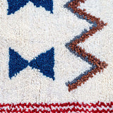 Prosperity Runner Moroccan Rug: featuring white, blue, tangerine, red, and black colors. Handcrafted with tribal symbols